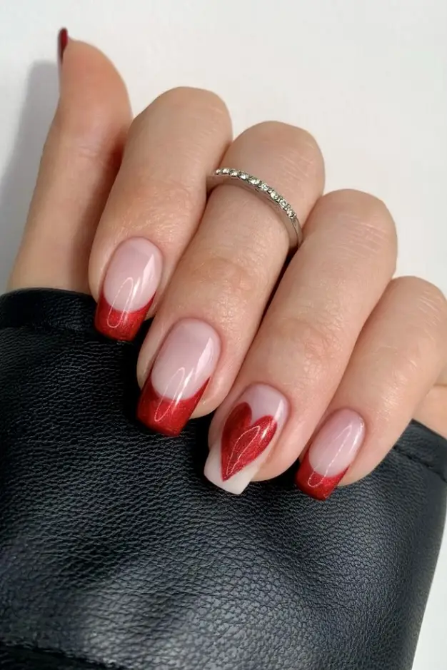 Bright red-tipped nails with a glossy finish and nude base