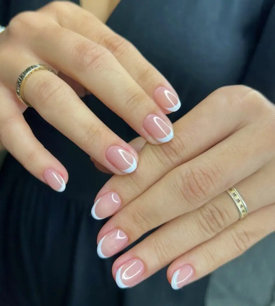 Short acrylic nails with gradient French tips blending white into nude tones