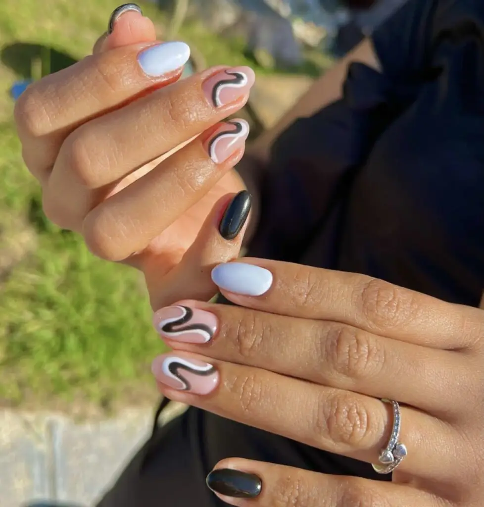 Short oval acrylic nails in a glossy deep taupe shade