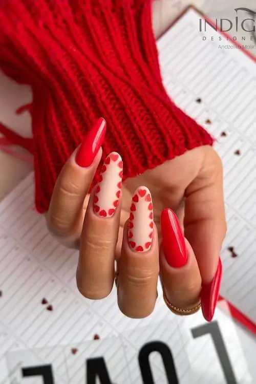 Color-blocked Valentine’s Day nails in red, pink, and white with geometric shapes