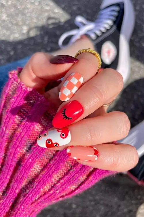 Clear Valentine’s Day nails with heart-shaped glitter accents