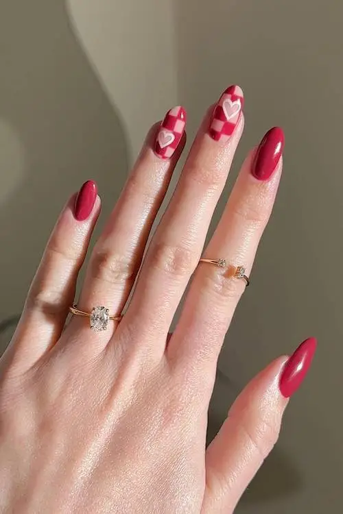 Glossy neutral nails with subtle heart tips for Valentine’s Day