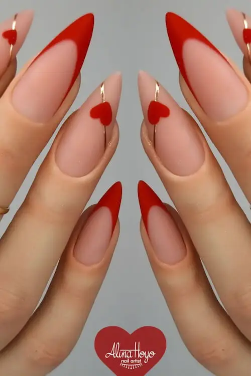 Fun Valentine's Day nail art with colorful hearts on a nude base