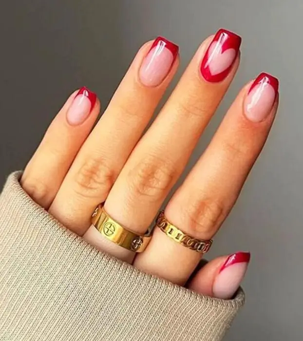 Pink and white nails with heart accents