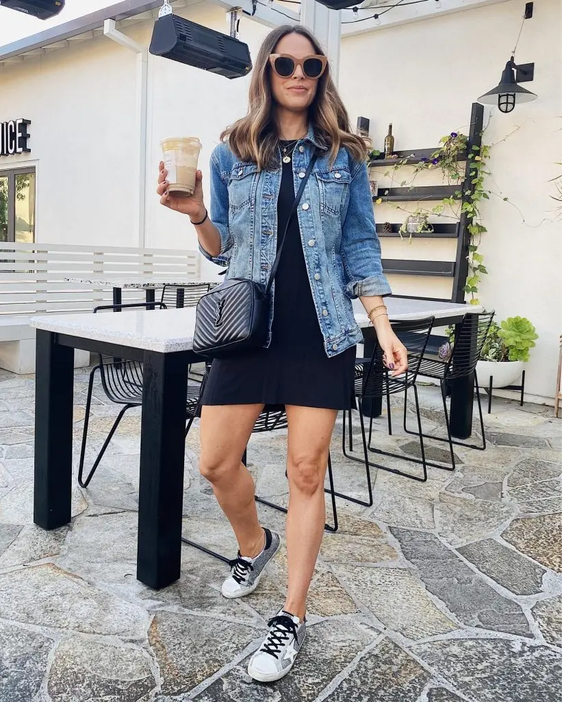 Light-wash denim jacket with fringed details along sleeves and back