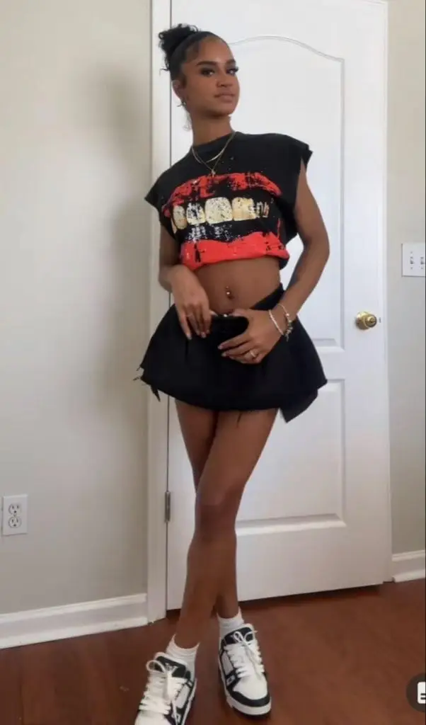 Black woman rocking a bold red two-piece vacation set with ruffles