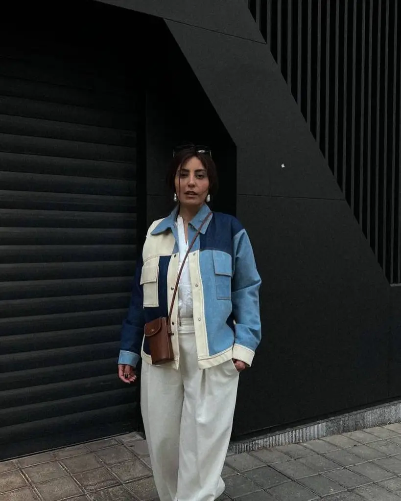 Denim jacket with colorful geometric patchwork on sleeves and back