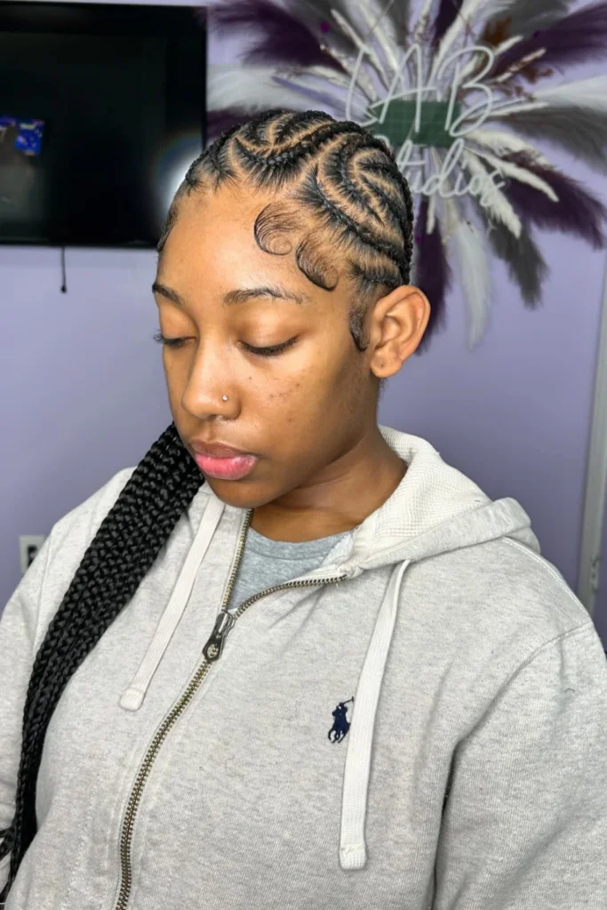 Alicia Keys wearing loose cornrows with golden hair rings and cascading lengths