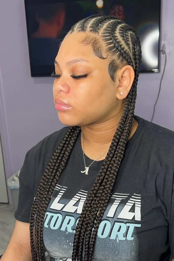 Alicia Keys with beaded cornrows enriched with shells and metallic accents