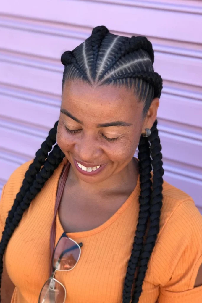 Alicia Keys with diagonal cornrows featuring colorful thread accents