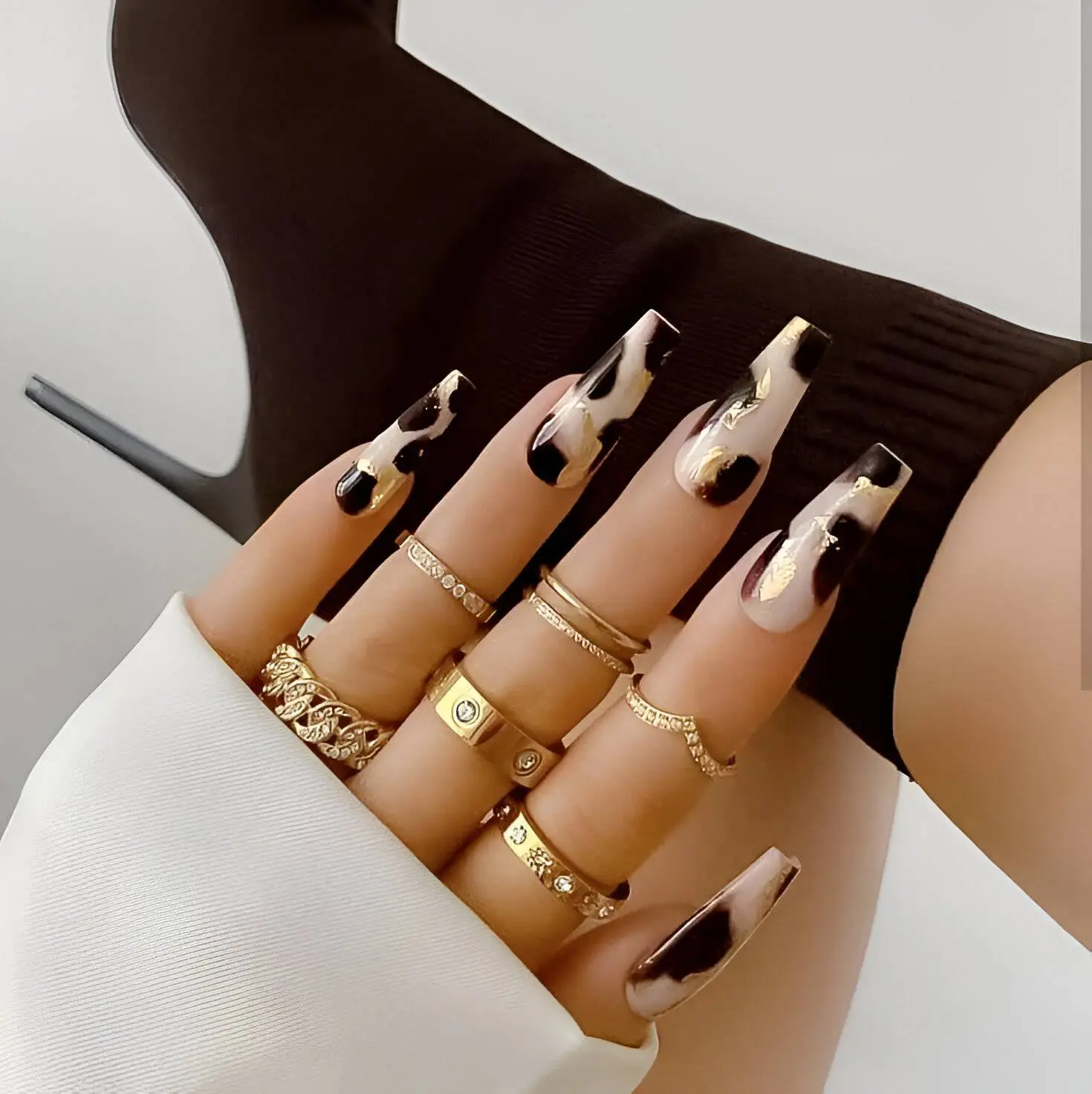 Glitter-Crowned Nude Coffin Nails with White Swirls