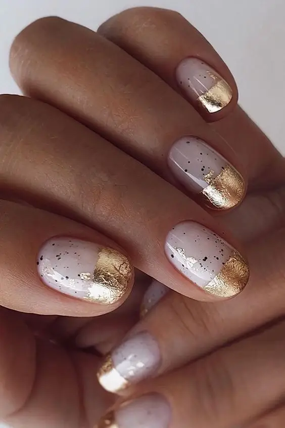 Short black acrylic nails with gold foil accents