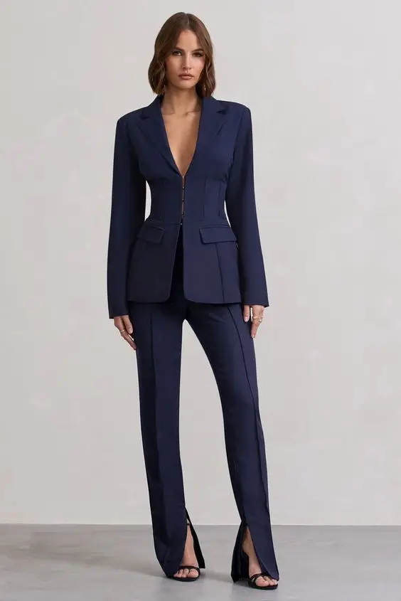 Business casual look featuring a black turtleneck layered with a gray coat and trousers