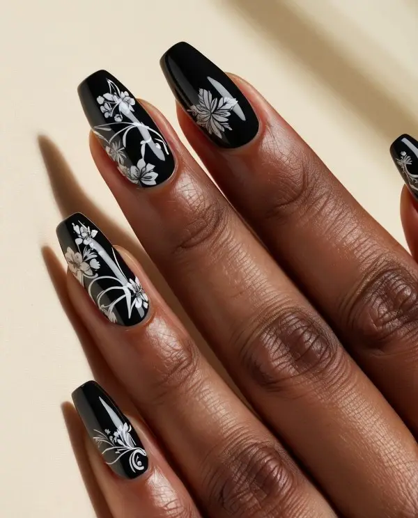 Black Nails with Subtle Metallic Embellishments