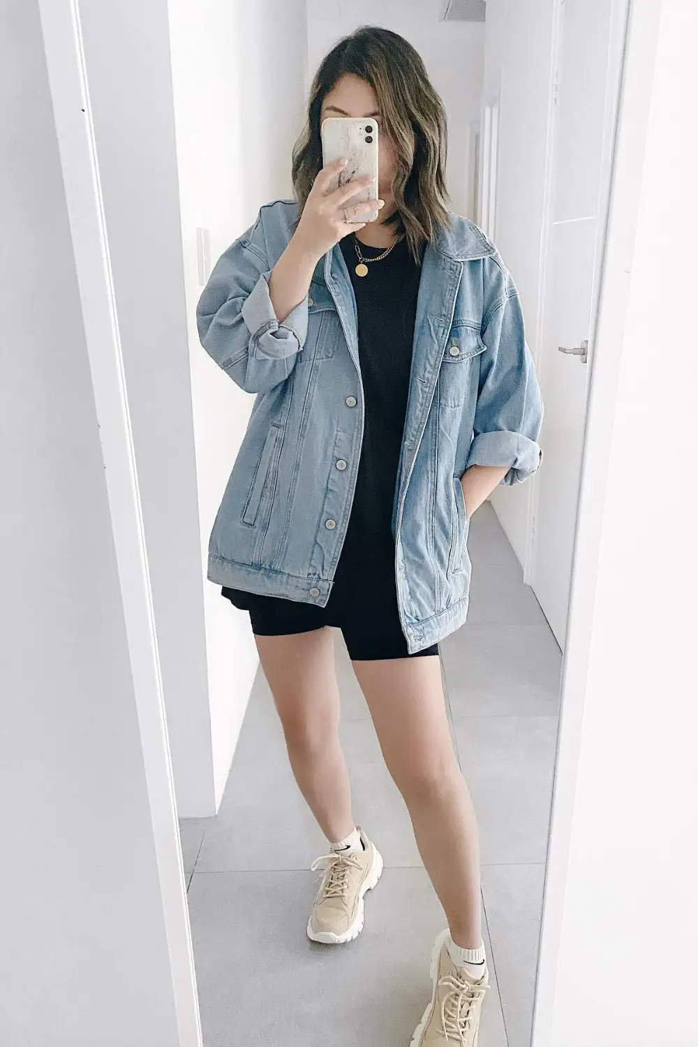 Oversized denim jacket with bold black typography design on back
