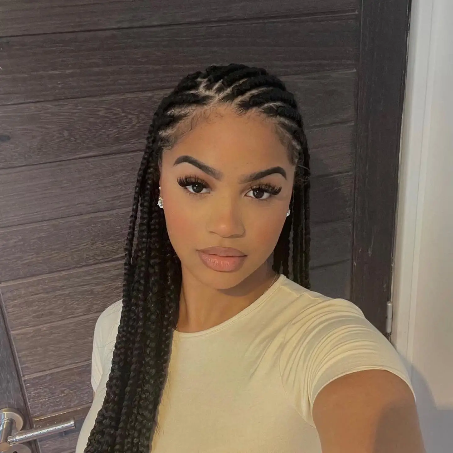 Side-parted goddess braids with loose, flowing ends