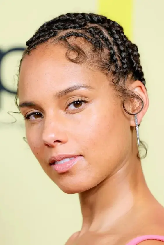 Alicia Keys wearing intricate snake-like braids that curve in artistic patterns