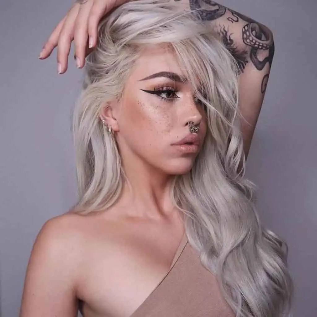 Woman with voluminous shag hairstyle and feathered ends