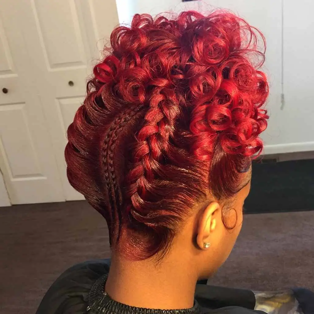 Spiraled parting with geometric goddess cornrows and cascading curls