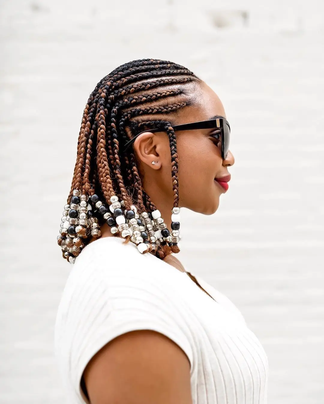 Sculptural cornrow updo with curved designs and height