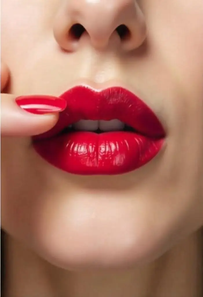 Edgy bold makeup featuring dark lipstick and dramatic cheekbones