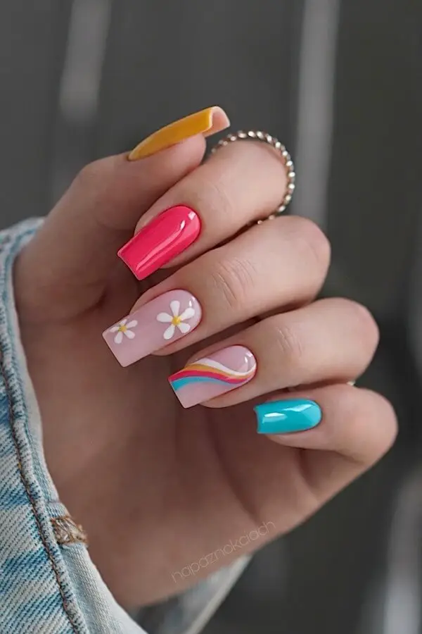Peach-colored nails with floral accents
