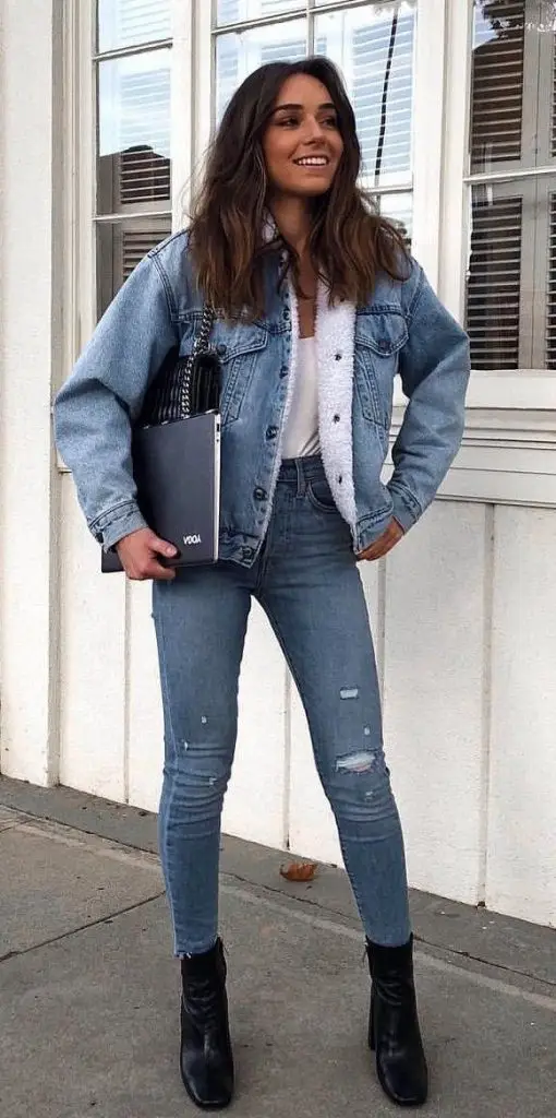 Light-wash jean jacket with sheer lace details along the sleeves and hemline